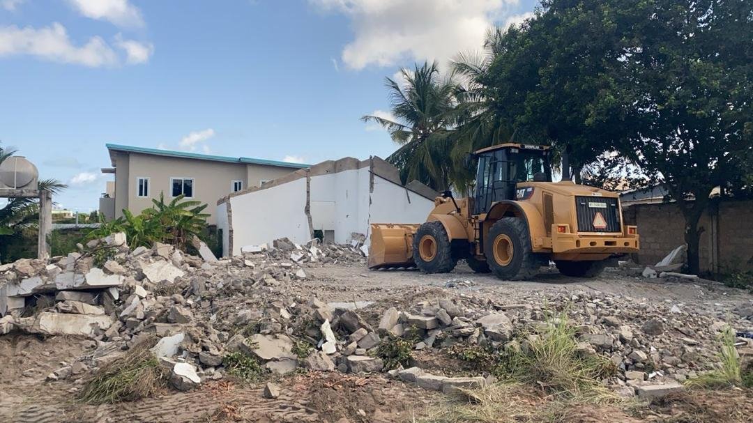 Wheel loader beside demolished structure